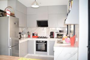 a white kitchen with white cabinets and appliances at VillaRama in Saint-Louis