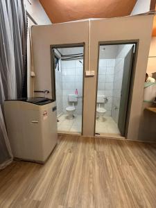 a bathroom with two toilets and a shower at Baby Devil Studio 8 pax Homestay in Sibu