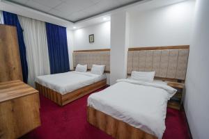 a hotel room with two beds at Danzha Hotel 1 in Erbil