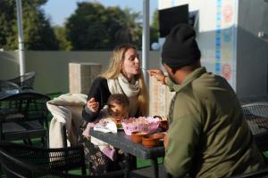 a man feeding a woman and a child at a picnic table at Nuba Nest in Aswan