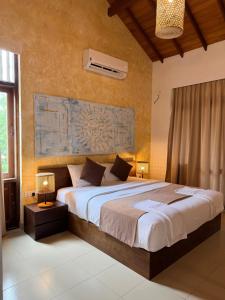 a bedroom with a large bed in a room at Aayu Lagoon in Negombo