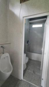 a bathroom with a toilet and a sink and a urinal at P'Moon Open Inn in Jasri +34 photos