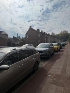 a row of cars parked on the side of a street at Deluxe Inn Gateshead in Gateshead