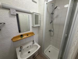 a white bathroom with a sink and a shower at GNDJ Hotel Skegness in Skegness +68 photos