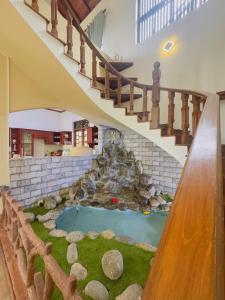 a house with a miniature garden under a staircase at Lanthana Villa Kandy in Kandy