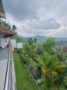 a view from the balcony of a house with palm trees at Lanthana Villa Kandy in Kandy