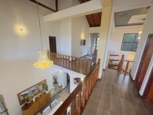 a room with a staircase and a chandelier at Lanthana Villa Kandy in Kandy