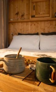 a wooden table with bowls and plates on a bed at Agriturismo Verdesole in Civitella San Paolo +9 photos