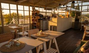 a restaurant with tables and chairs and a kitchen at Agriturismo Verdesole in Civitella San Paolo