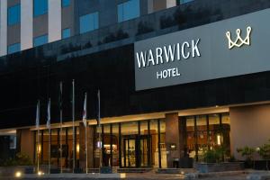 a building with a sign for a hotel at Warwick Hotel Al Safa - Jeddah in Jeddah