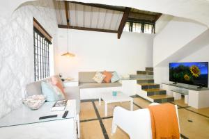a living room with a couch and a tv at Beach Escape in Trou d'Eau Douce