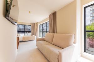 a living room with a couch and a window at A2B Collection Arena in Valencia