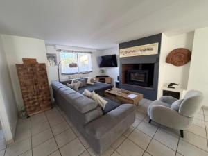 a living room with a couch and a fireplace at Villa Mars YourHostHelper in Narbonne