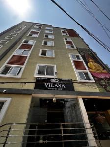 a tall building with a sign for a villa at Vilasa stays and colive in Hyderabad +5 photos