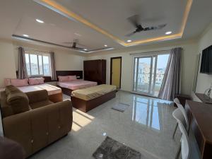 a living room with a couch and a bed at Vilasa stays and colive in Hyderabad