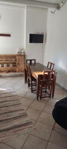 a dining room with a wooden table and chairs at Casa Mauri in Cusino