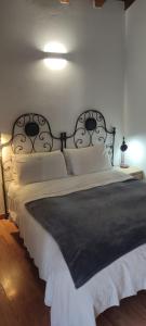 a bedroom with a large bed with a black headboard at Casa Mauri in Cusino