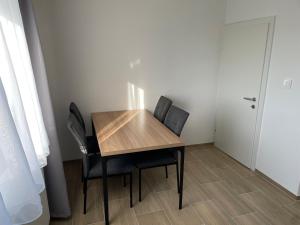 a table and chairs in a room with a door at GrafOne Apartment in Waizenkirchen +11 photos