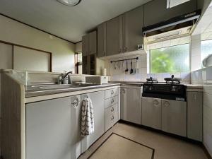 a large kitchen with a sink and a stove at 2nd Home Kaminagayoshi in Ichihara