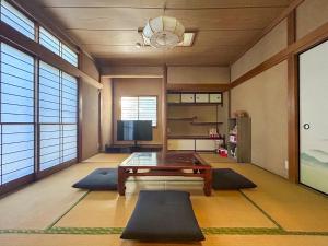 a living room with a table and some rugs at 2nd Home Kaminagayoshi in Ichihara