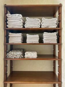 a shelf filled with lots of white towels at 2nd Home Kaminagayoshi in Ichihara +48 photos