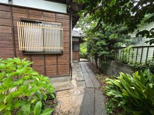 a house with a wooden door and a fence at 2nd Home Kaminagayoshi in Ichihara
