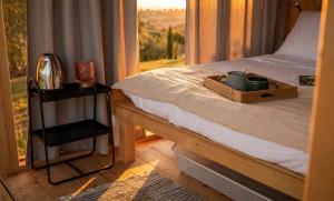 a bedroom with a bed and a window with a tray on it at Agriturismo Verdesole in Civitella San Paolo