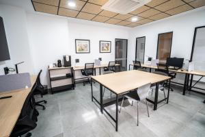 an office with desks and tables and chairs at OIKOS APARTAMENTOS TURÍSTICOS in Monesterio +180 photos