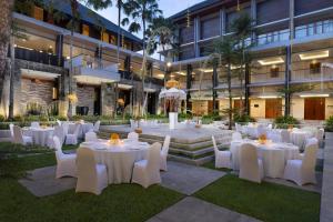 a courtyard with white tables and chairs in front of a building at Courtyard by Marriott Bali Nusa Dua Resort in Nusa Dua +108 photos
