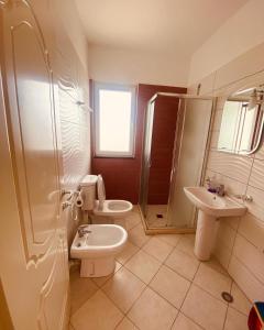 a bathroom with two toilets and a shower and a sink at Mare Nostrum Residence in Shëngjin +18 photos