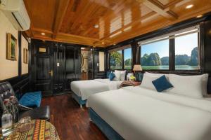 a hotel room with two beds and a window at Overnight Cruise in Hai Phong
