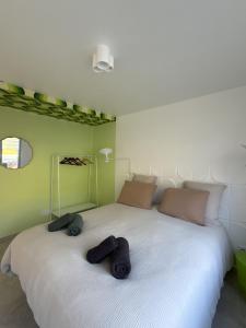 a bedroom with a large white bed with two towels on it at La Bergerie 2 in Neufchâteau