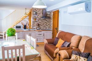 a living room with a couch and a table at Casa Corralazos in Castril +17 photos