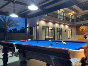 a pool table in front of a house at บ้านบรรยากาศ พูลวิลล่าชะอำ in Ban Bo Prakhon