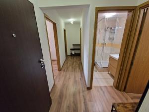 a hallway of a bathroom with a shower and a sink at Caparica City & Beach in Caparica +24 photos
