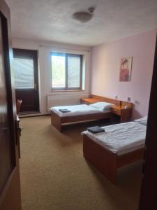 a room with two beds and a window at Hotel Na Jižní in Přerov