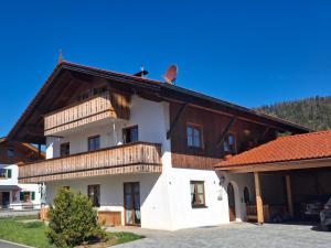 a large white building with a red roof at Haus Rosamirl Ferienwohnung in Wallgau