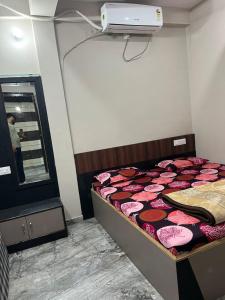 a bedroom with a bed and a mirror in it at Morpankh guest house in Rīngas