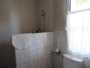 a bathroom with a tub and a toilet and a window at Casa adosada en Calella de Palafrugell in Palafrugell +12 photos