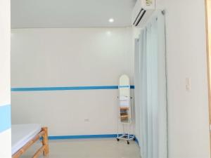 a hospital room with a bed and a hallway at Juliet's Homestay in Moalboal