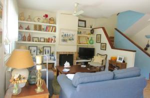 a living room with a blue couch and a table at Casa adosada en Calella de Palafrugell in Palafrugell