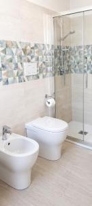 a bathroom with a toilet and a sink and a shower at Sosta al 101 - Alloggio turistico in Grammichele