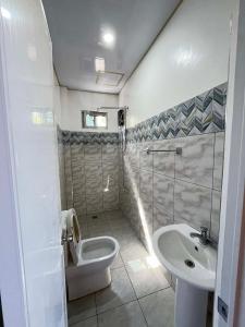 a bathroom with a toilet and a sink at Juliet's Homestay in Moalboal