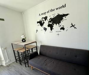 a map of the world on a wall in a living room at Appartement VAIS in Cognac +1 photo