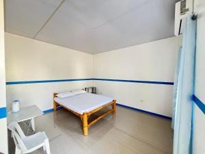 a room with a bed and a table and a chair at Juliet's Homestay in Moalboal