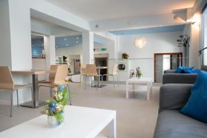 a living room with a couch and a table at Hotel Estense in Bellaria-Igea Marina