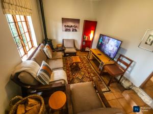 a living room with a couch and a tv at The GingerPig Inn in Die Ark
