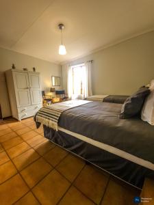 a bedroom with two beds and a window at The GingerPig Inn in Die Ark