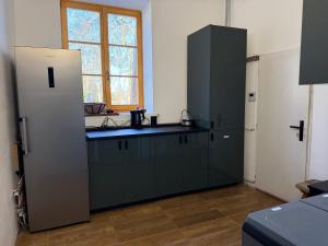 a kitchen with green cabinets and a black counter top at Krušnohorský Poutník in Kovářská