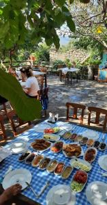 a blue table with plates of food on it at Vama Konuk Evi in Gokceada Town